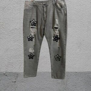 A Pair Of Gray Star Patch Distressed Jeans